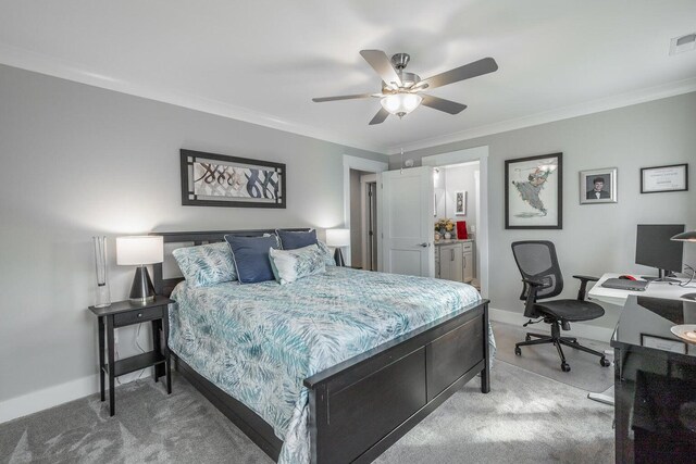 carpeted bedroom featuring ceiling fan, ensuite bath, and ornamental molding