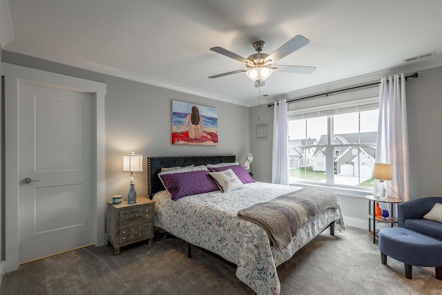 carpeted bedroom with ornamental molding and ceiling fan