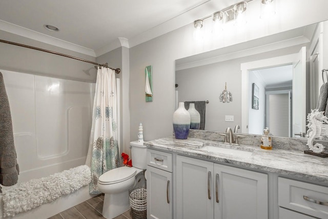 full bathroom with vanity, ornamental molding, wood-type flooring, shower / tub combo, and toilet