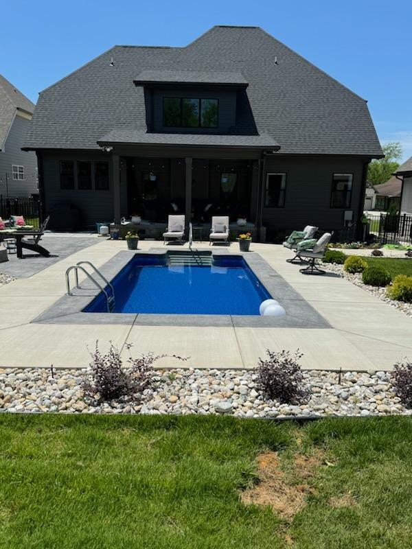 view of pool with a yard and a patio area