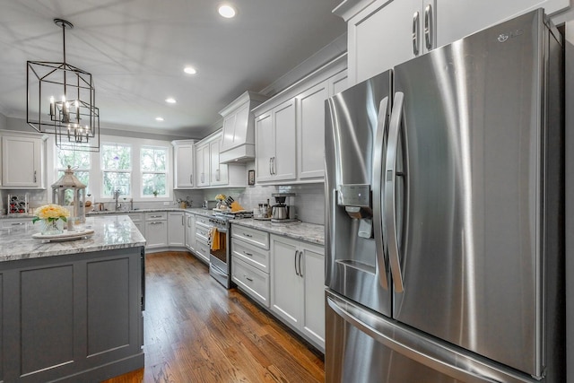 kitchen with white cabinetry, light stone countertops, dark wood-type flooring, and stainless steel appliances