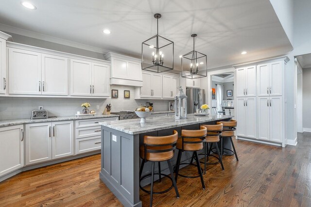 kitchen with a center island, dark hardwood / wood-style flooring, and white cabinets