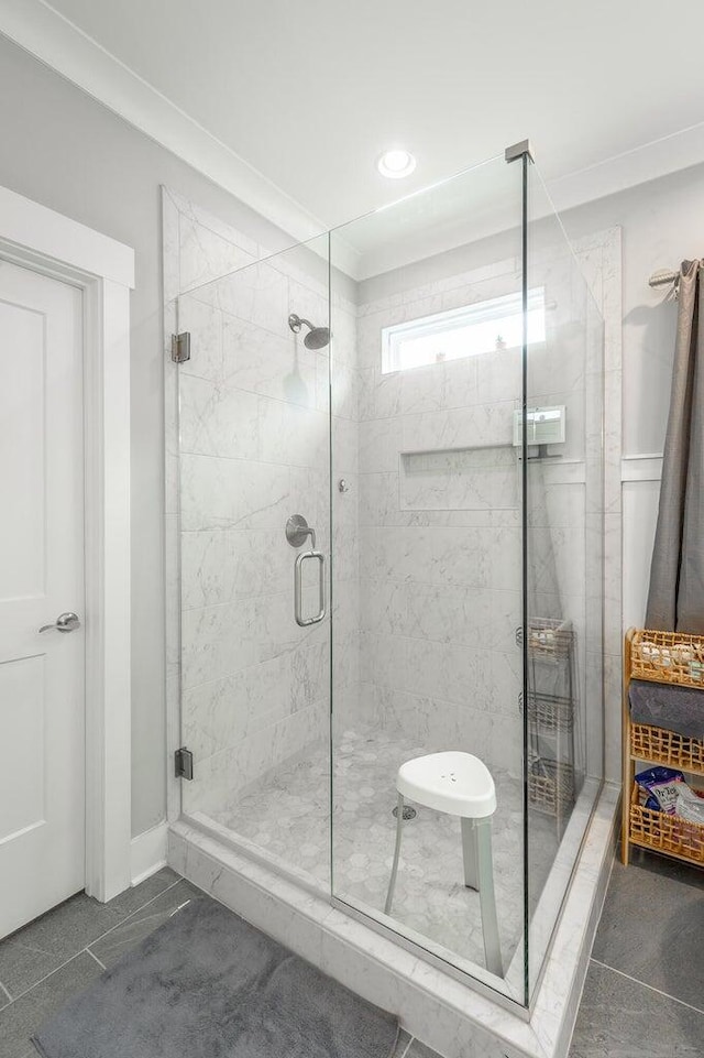 bathroom with tile patterned flooring and a shower with door