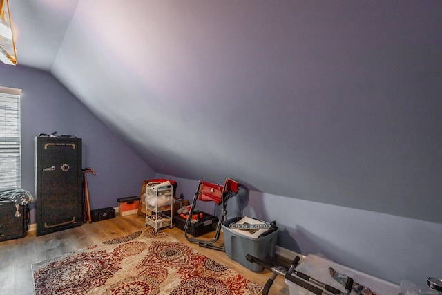 game room with light wood-type flooring and vaulted ceiling