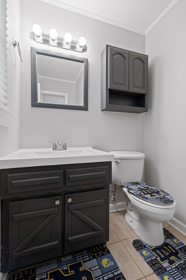 bathroom featuring ornamental molding, vanity, tile patterned flooring, and toilet