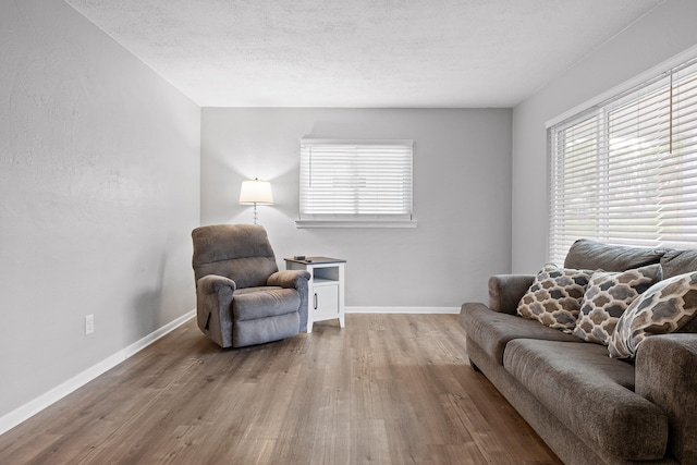 interior space with a textured ceiling and hardwood / wood-style flooring