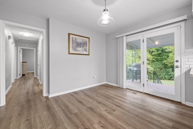 empty room with light hardwood / wood-style flooring