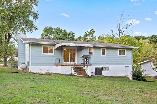 rear view of house with a yard