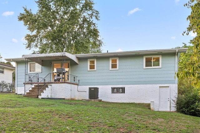 back of house with a lawn, a porch, and central air condition unit