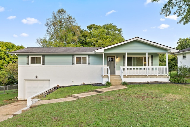 view of front facade featuring a front yard, a garage, and a porch