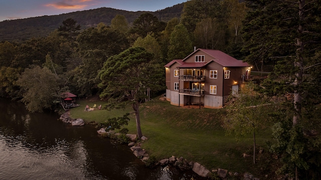 exterior space with a water and mountain view