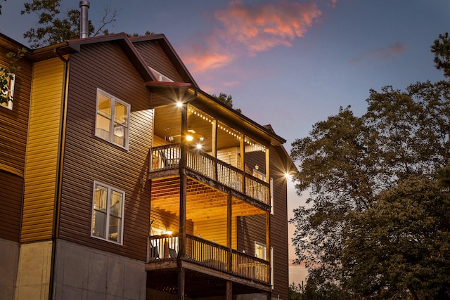 property exterior at dusk with a balcony