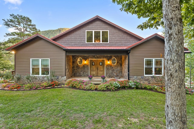 view of front facade with a front yard and covered porch