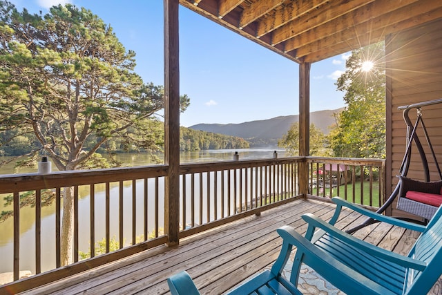 wooden deck featuring a water and mountain view