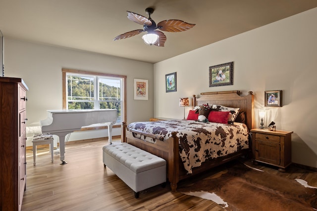 bedroom with ceiling fan and hardwood / wood-style floors