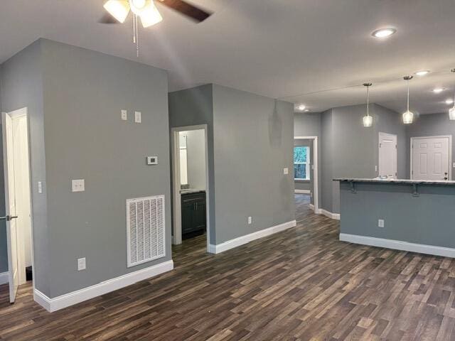 unfurnished living room with dark wood-type flooring and ceiling fan