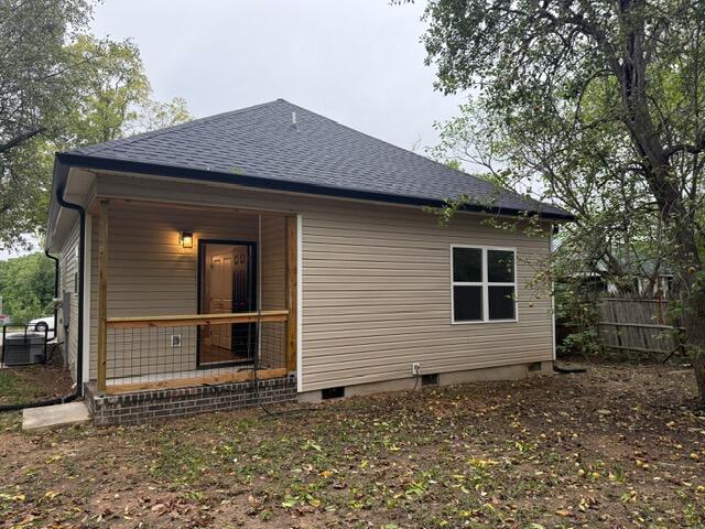 back of house with central air condition unit