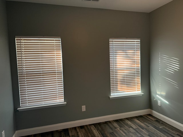 unfurnished room featuring dark wood-type flooring