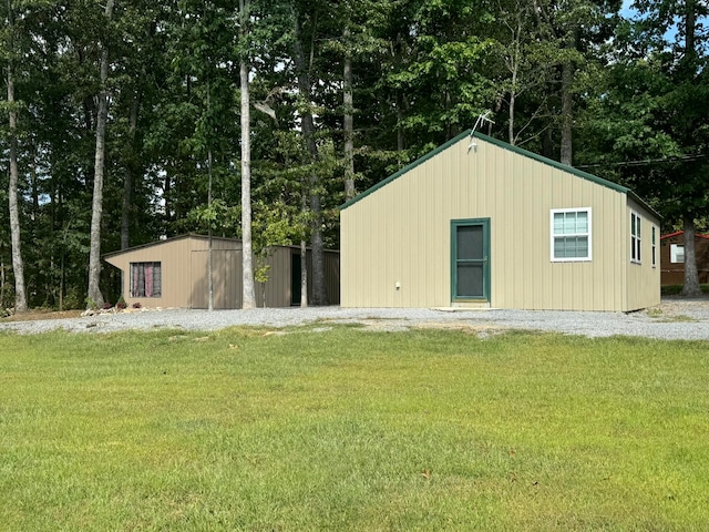 view of outbuilding featuring a yard