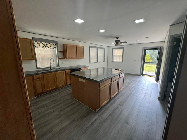 kitchen featuring dark hardwood / wood-style flooring, ceiling fan, a center island, and sink