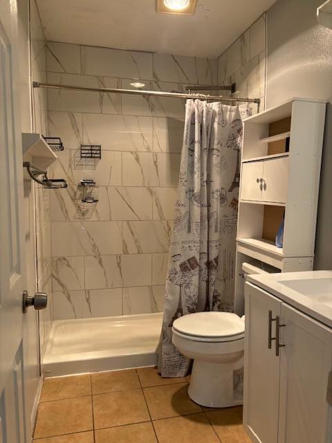 bathroom featuring vanity, toilet, tile patterned floors, and a shower with curtain