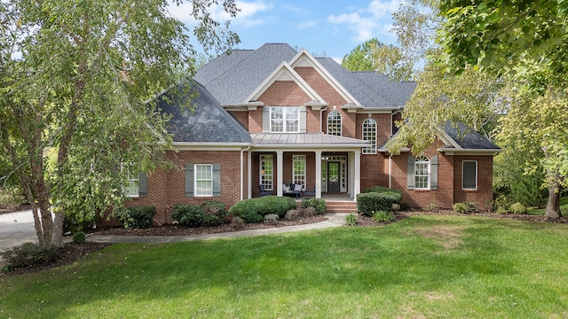 craftsman inspired home featuring a porch and a front lawn