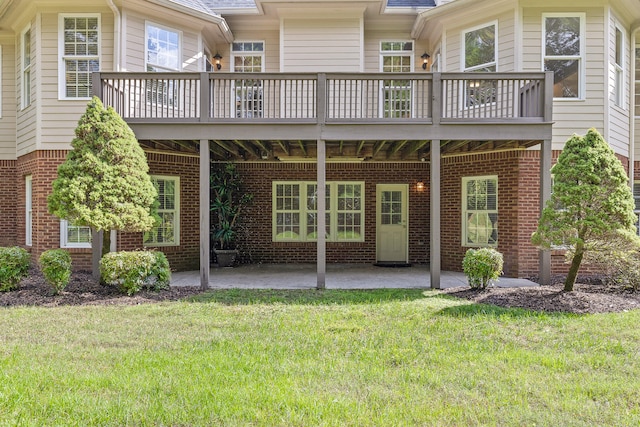 rear view of house with a lawn and a patio area