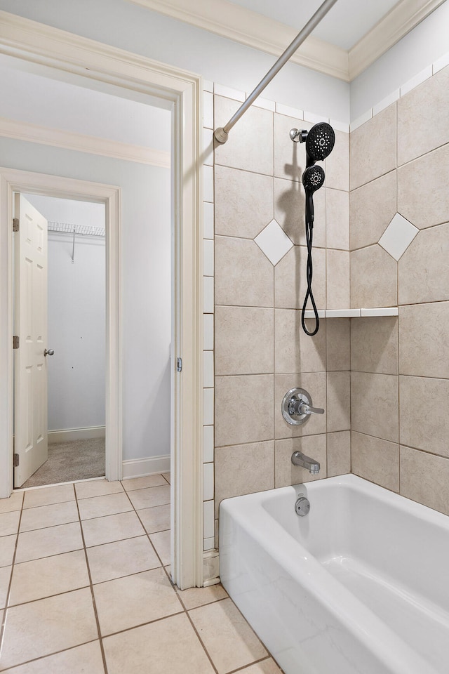 bathroom with tiled shower / bath combo, crown molding, and tile patterned flooring