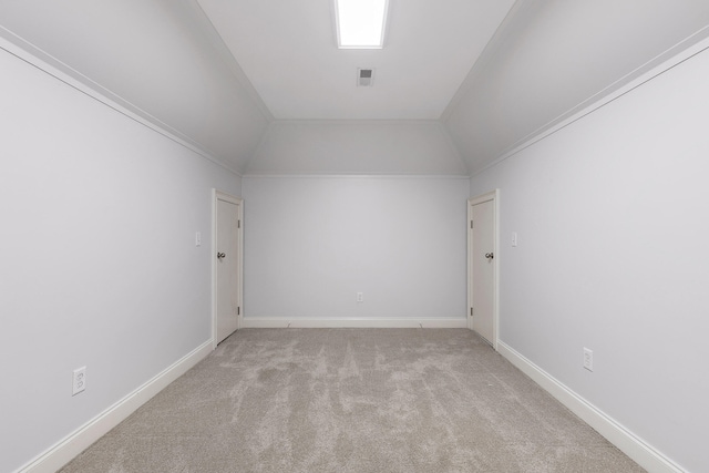 bonus room with light colored carpet and lofted ceiling