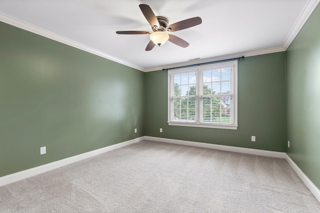 carpeted spare room featuring ceiling fan and ornamental molding