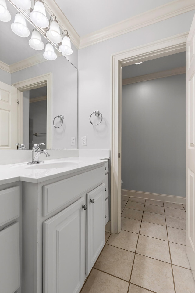 bathroom with crown molding, tile patterned flooring, and vanity