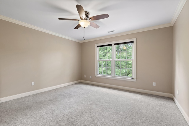 carpeted empty room with ceiling fan and crown molding