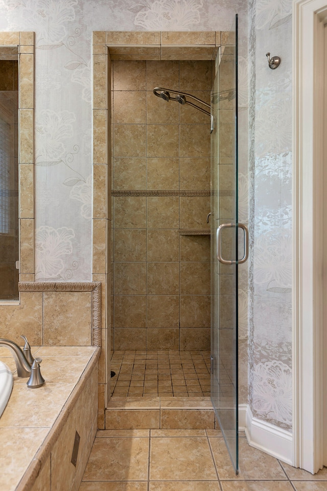 bathroom with tile patterned flooring and an enclosed shower