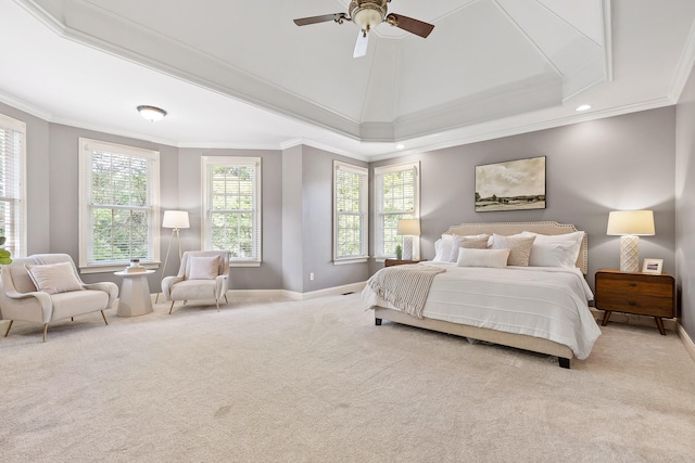 carpeted bedroom featuring ornamental molding, a tray ceiling, and ceiling fan