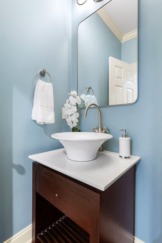 bathroom featuring crown molding and vanity