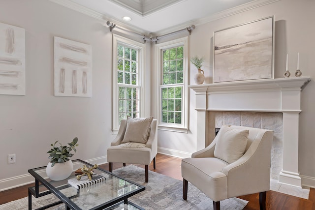 living area with ornamental molding and hardwood / wood-style floors