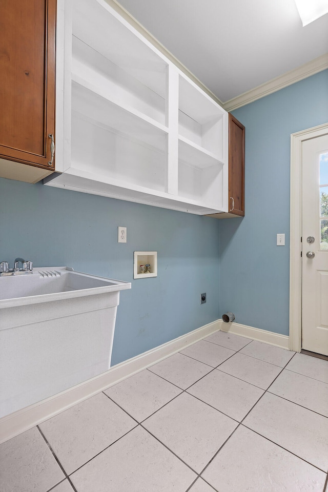 laundry room featuring cabinets, electric dryer hookup, hookup for a washing machine, and light tile patterned floors