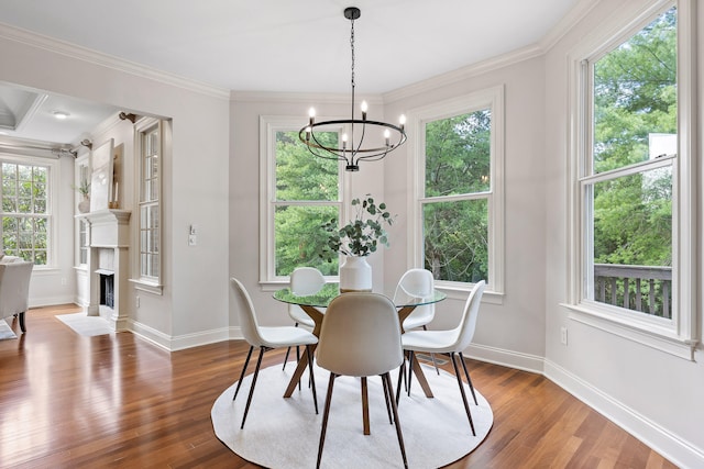 dining area with an inviting chandelier, hardwood / wood-style flooring, and crown molding