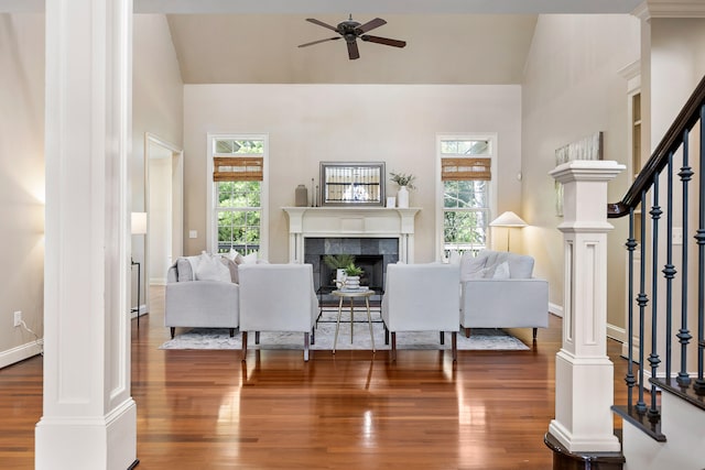 living room featuring a fireplace, dark hardwood / wood-style flooring, and a wealth of natural light