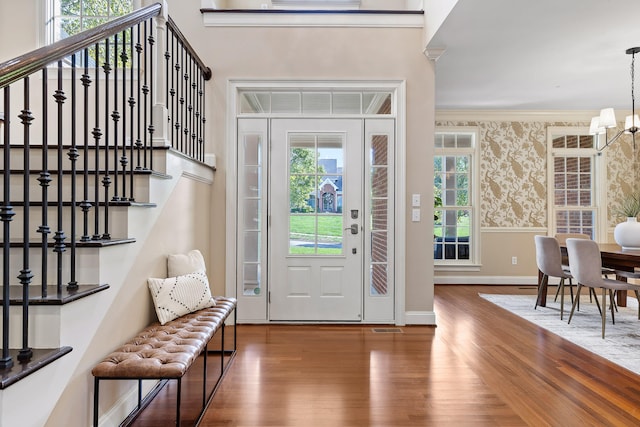 entryway with crown molding, dark hardwood / wood-style flooring, and a wealth of natural light