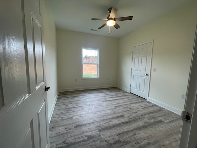 unfurnished room with light hardwood / wood-style flooring and ceiling fan