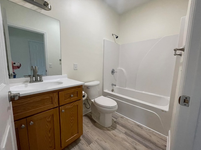 full bathroom featuring vanity, shower / bath combination, toilet, and hardwood / wood-style flooring