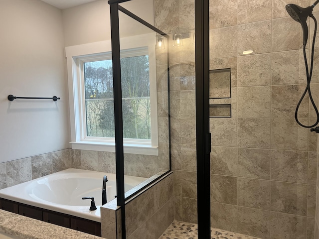 bathroom featuring separate shower and tub