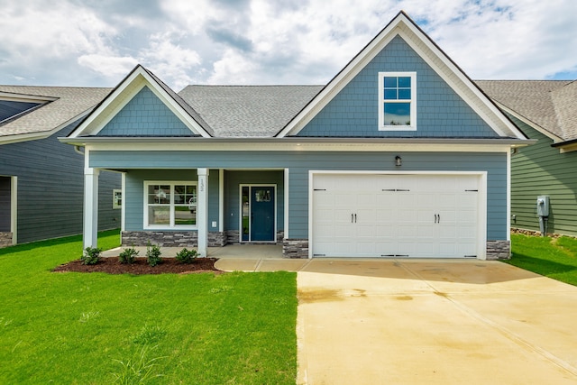 craftsman house featuring a garage, a front lawn, and covered porch