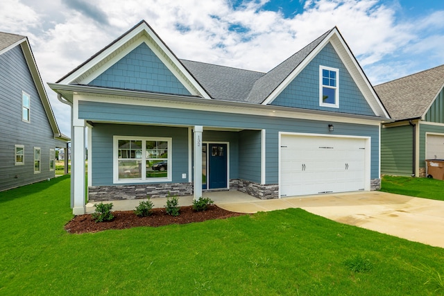 craftsman-style home featuring a garage, a front lawn, and a porch