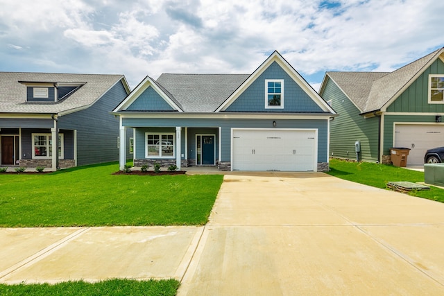 craftsman-style home featuring covered porch, a garage, and a front lawn