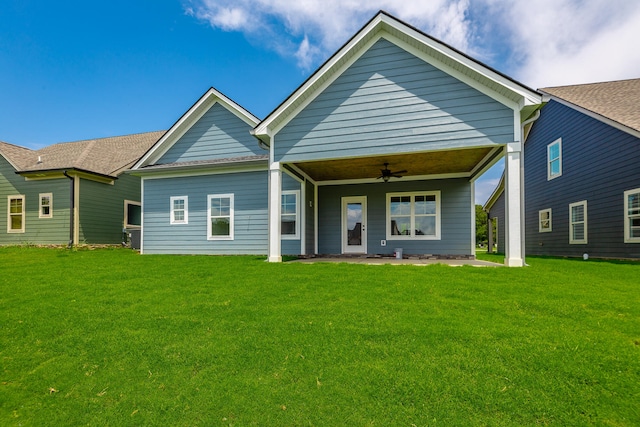 view of front of property with a front lawn, ceiling fan, and a patio