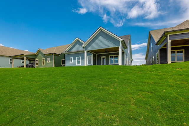 back of property featuring a lawn