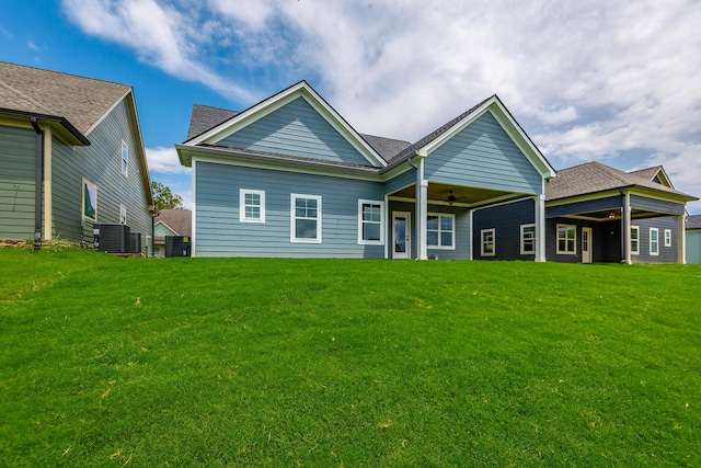 back of house with ceiling fan, central AC, and a yard