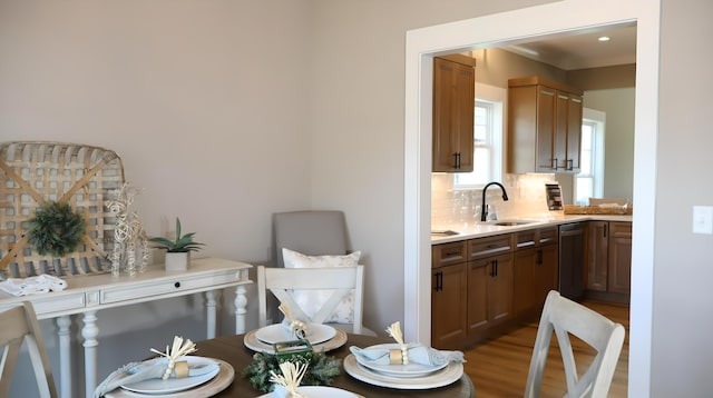 dining space featuring sink and light hardwood / wood-style flooring